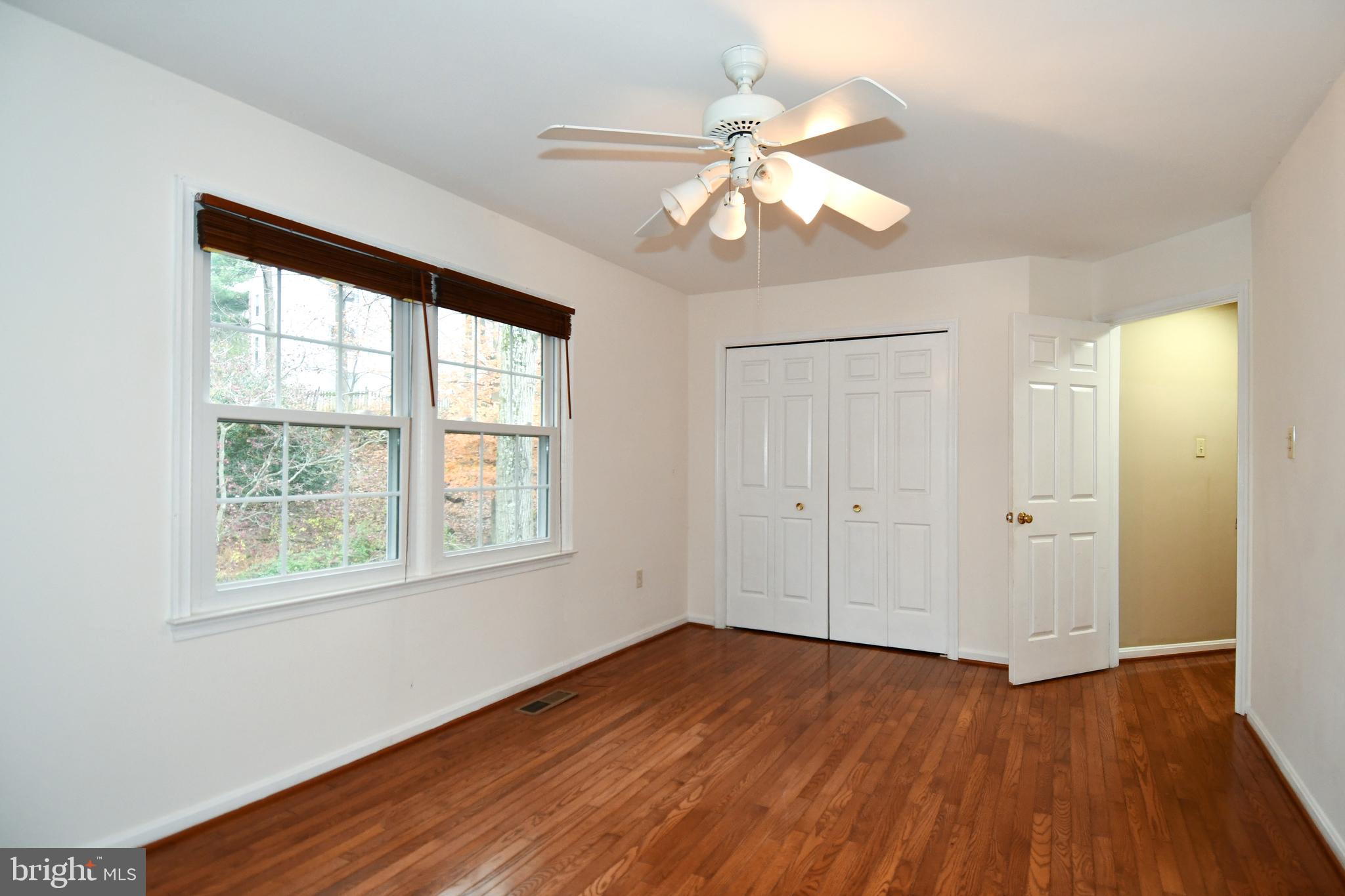 13135 Hutchinson Way Silver Spring, MD 20906 - Photo 45 of 64 a view of an empty room with wooden floor and a window