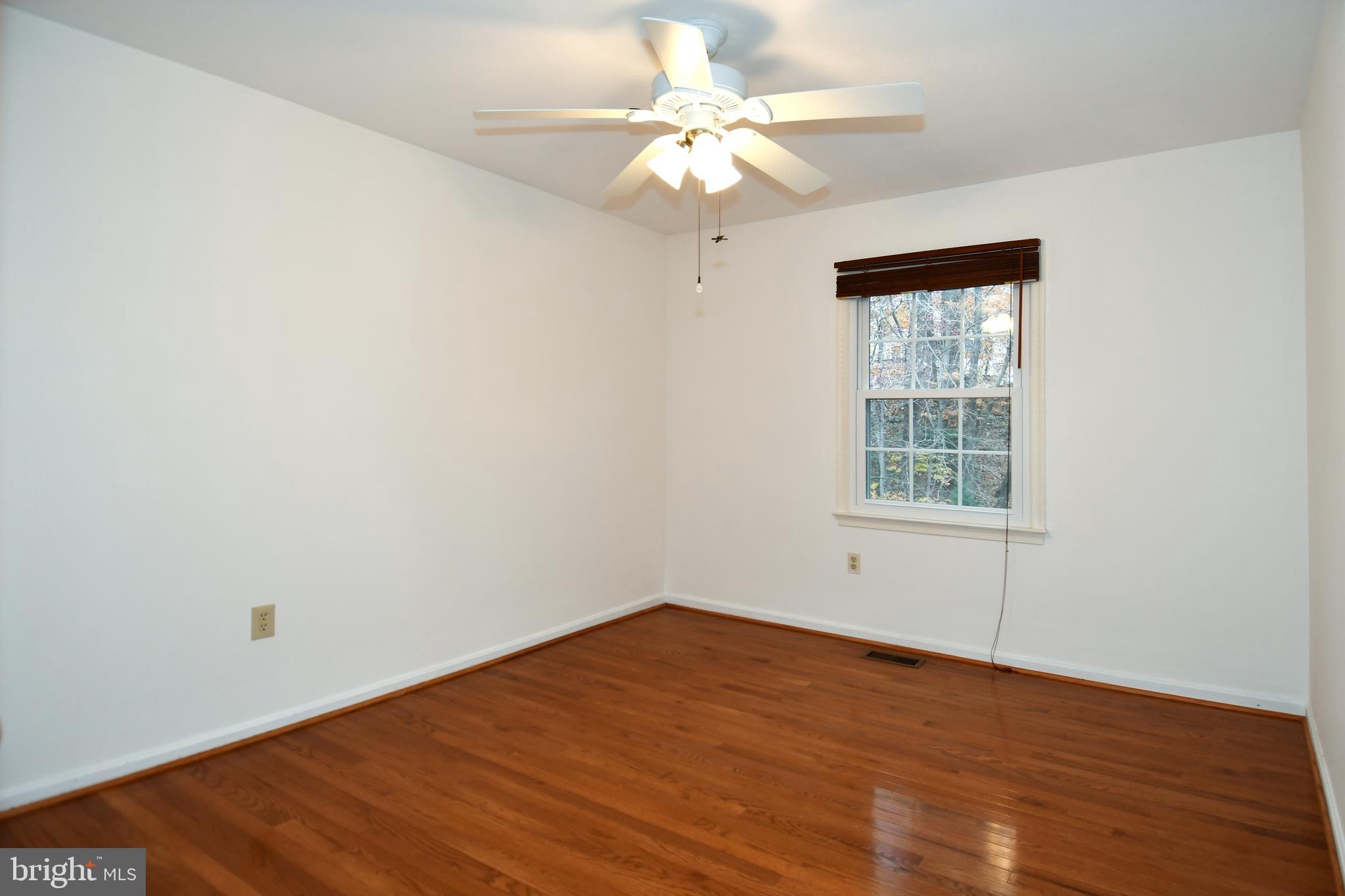 13135 Hutchinson Way Silver Spring, MD 20906 - Photo 46 of 64 wooden floor in an empty room with a window