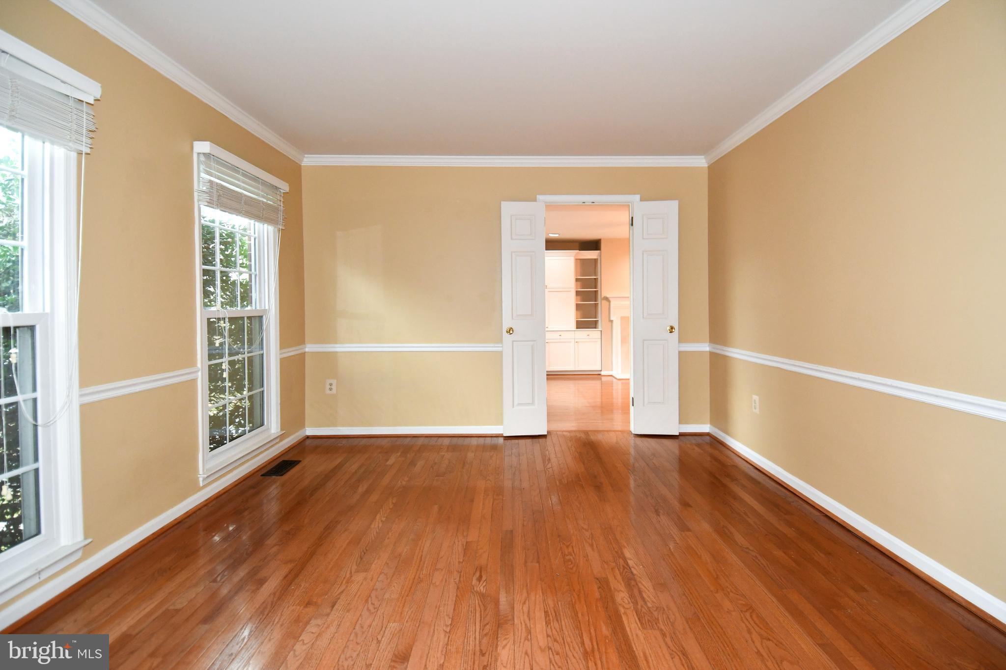 13135 Hutchinson Way Silver Spring, MD 20906 - Photo 6 of 64 a view of an empty room with wooden floor and a window