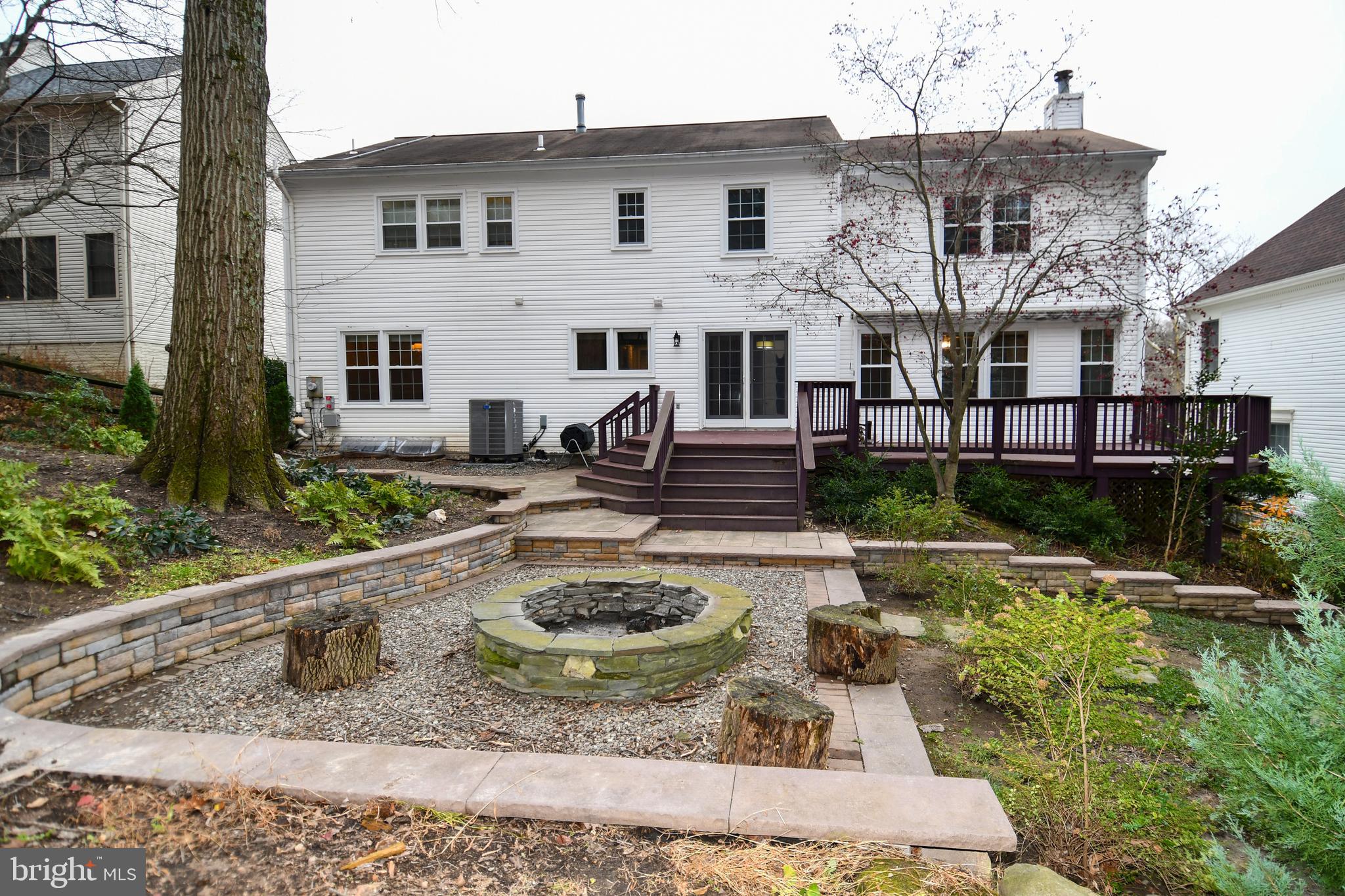 13135 Hutchinson Way Silver Spring, MD 20906 - Photo 63 of 64 a view of a white house with large yard plants and large tree