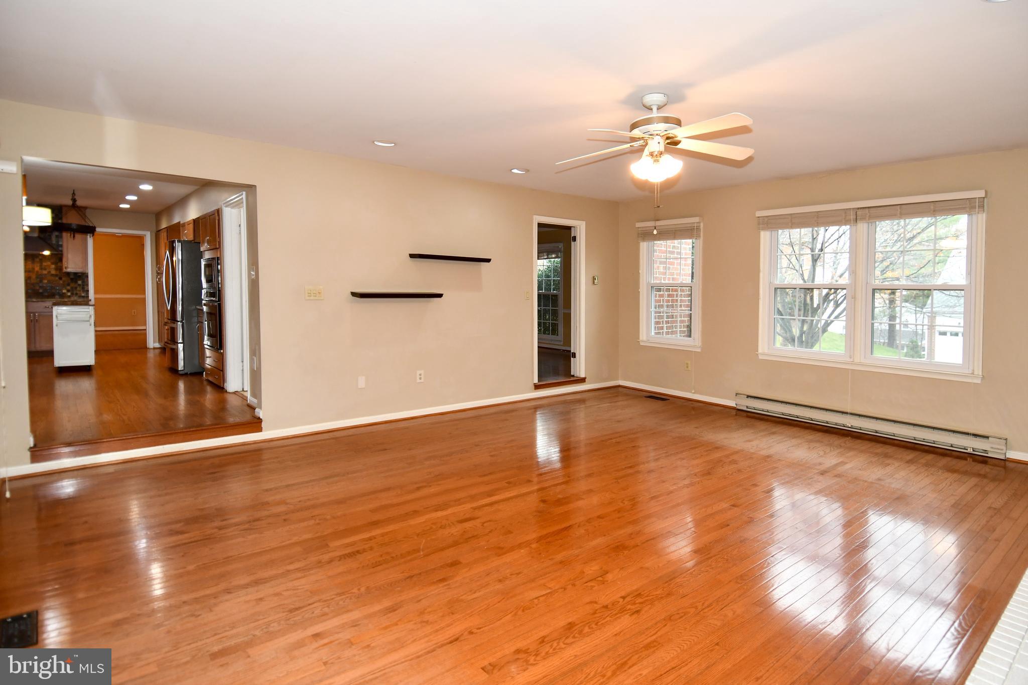 13135 Hutchinson Way Silver Spring, MD 20906 - Photo 7 of 64 a view of an empty room with wooden floor and a window