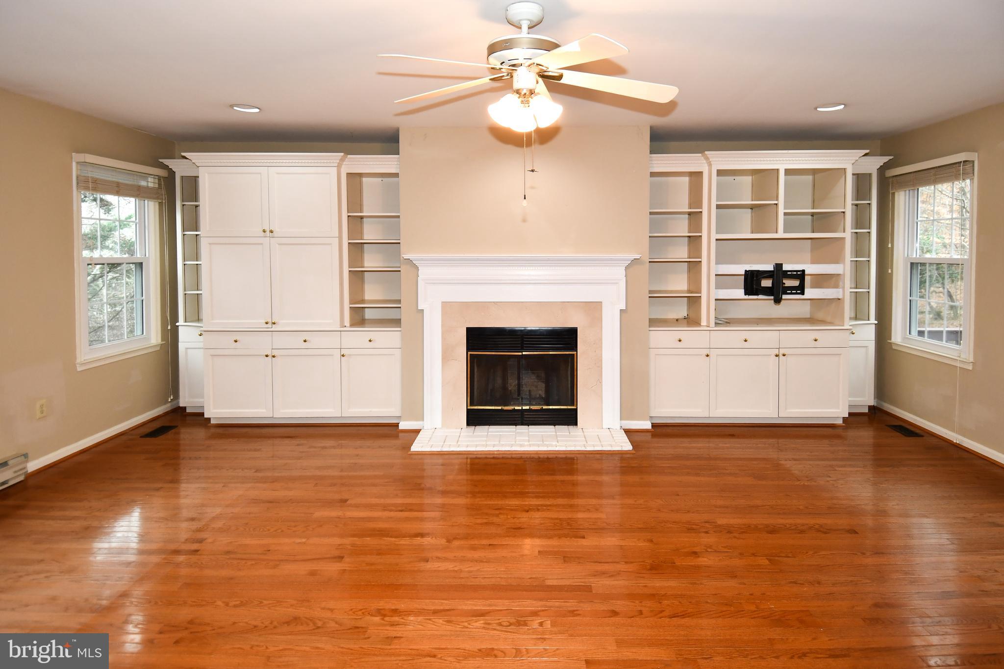 13135 Hutchinson Way Silver Spring, MD 20906 - Photo 9 of 64 wooden floor fireplace and windows in an empty room