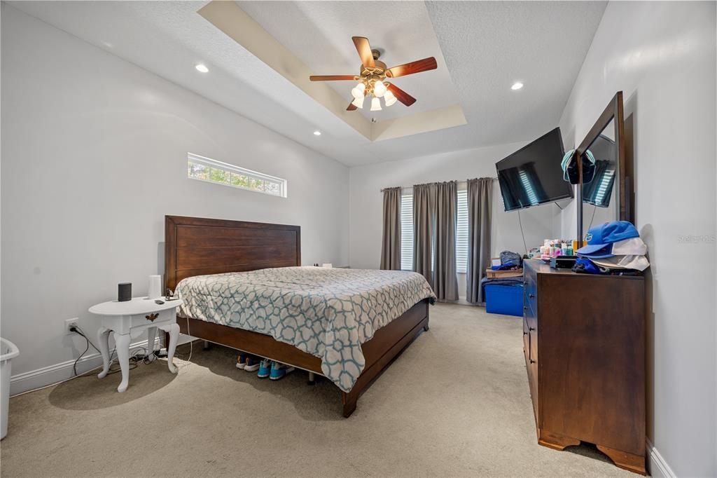 9312 Southwest 152nd Court Lake Butler, FL 32054 - Photo 14 of 37 a bedroom with a bed and a chandelier