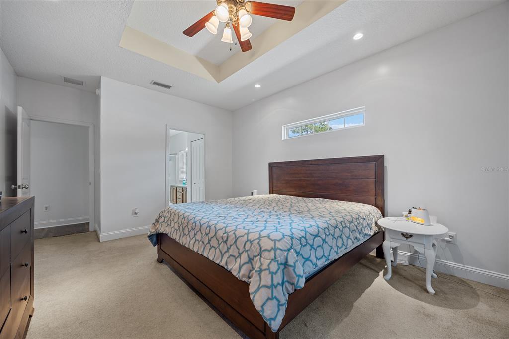 9312 Southwest 152nd Court Lake Butler, FL 32054 - Photo 15 of 37 a bedroom with a bed and a chandelier