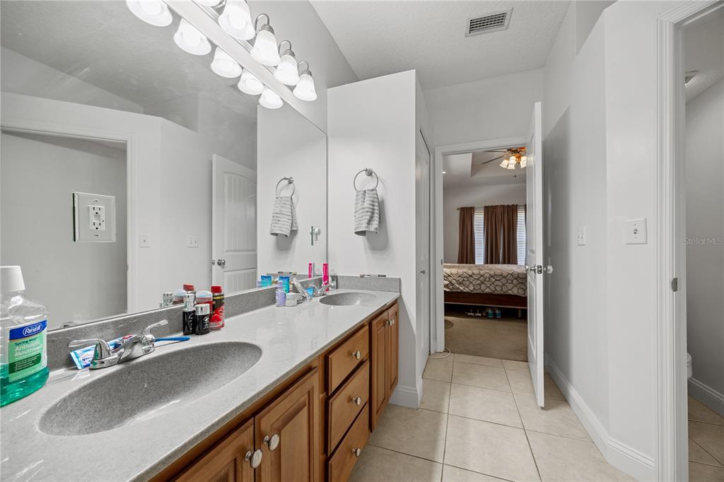 9312 Southwest 152nd Court Lake Butler, FL 32054 - Photo 17 of 37 a en suite bathroom with a double vanity sink a mirror and a shower