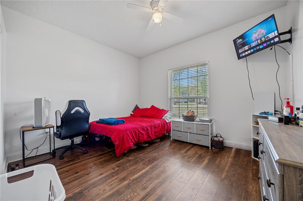 9312 Southwest 152nd Court Lake Butler, FL 32054 - Photo 18 of 37 a bedroom with furniture and a window