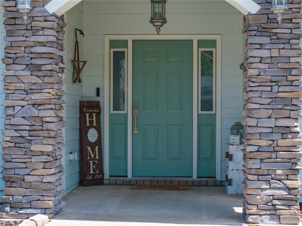 9312 Southwest 152nd Court Lake Butler, FL 32054 - Photo 2 of 37 a front view of a house with a potted plant