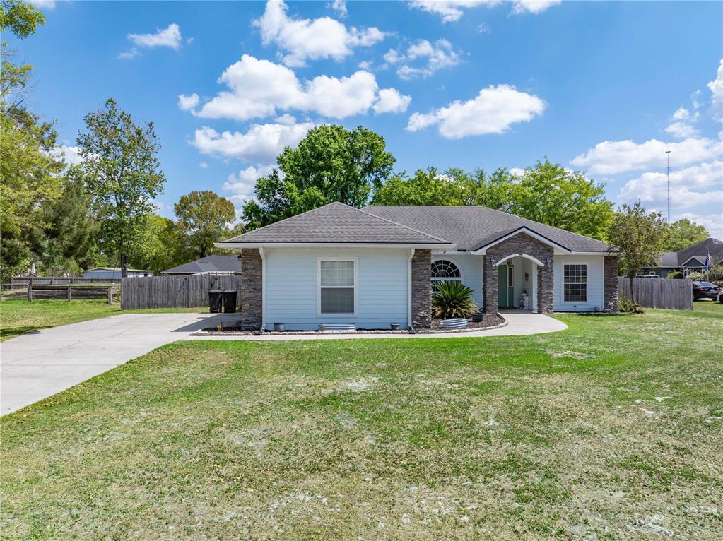 9312 Southwest 152nd Court Lake Butler, FL 32054 - Photo 3 of 37 a front view of a house with garden