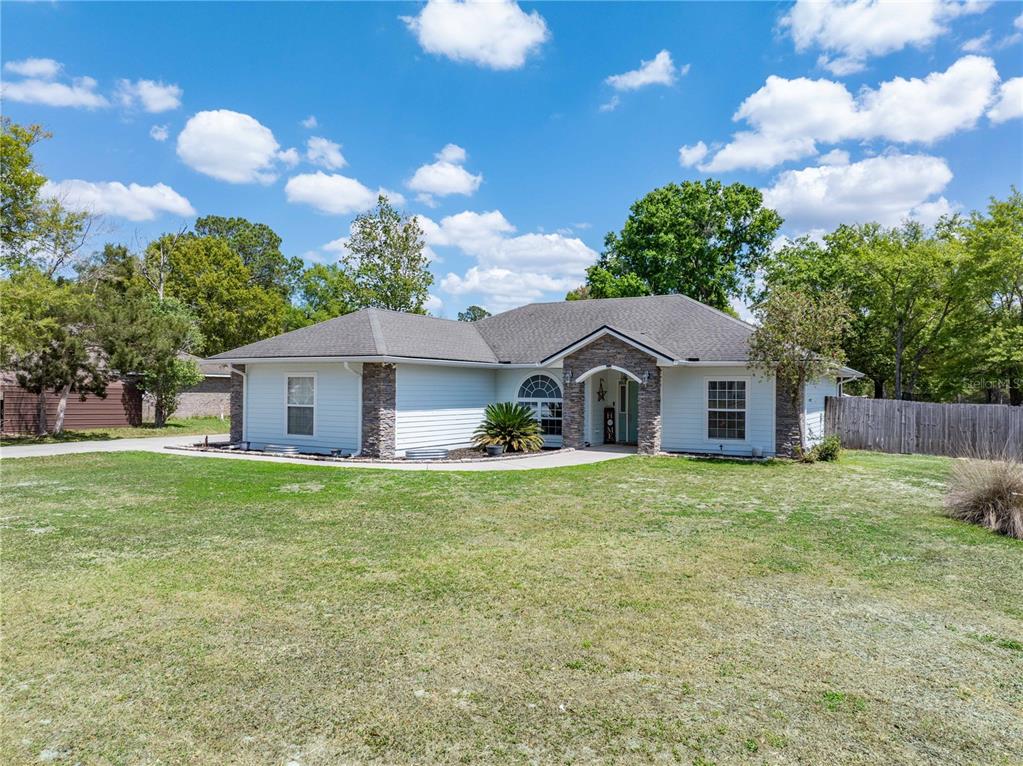 9312 Southwest 152nd Court Lake Butler, FL 32054 - Photo 4 of 37 a front view of a house with garden