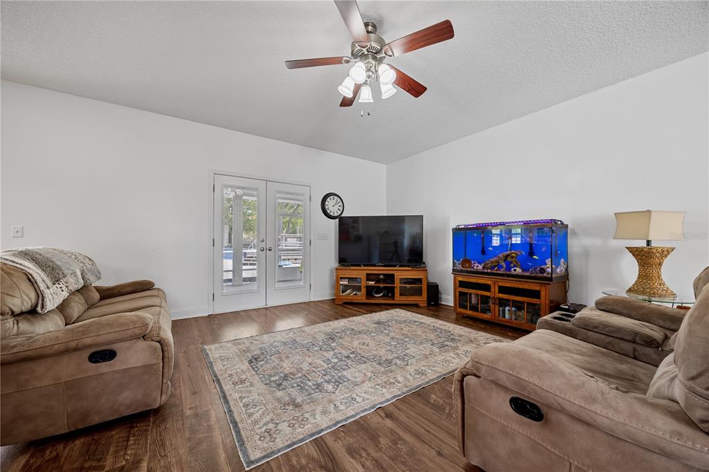 9312 Southwest 152nd Court Lake Butler, FL 32054 - Photo 8 of 37 a living room with furniture and a flat screen tv