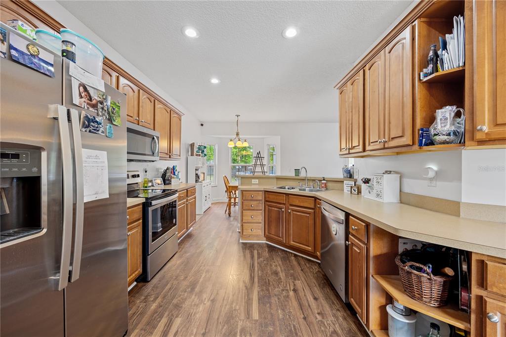 9312 Southwest 152nd Court Lake Butler, FL 32054 - Photo 10 of 37 a kitchen with stainless steel appliances granite countertop a stove a sink dishwasher and a refrigerator