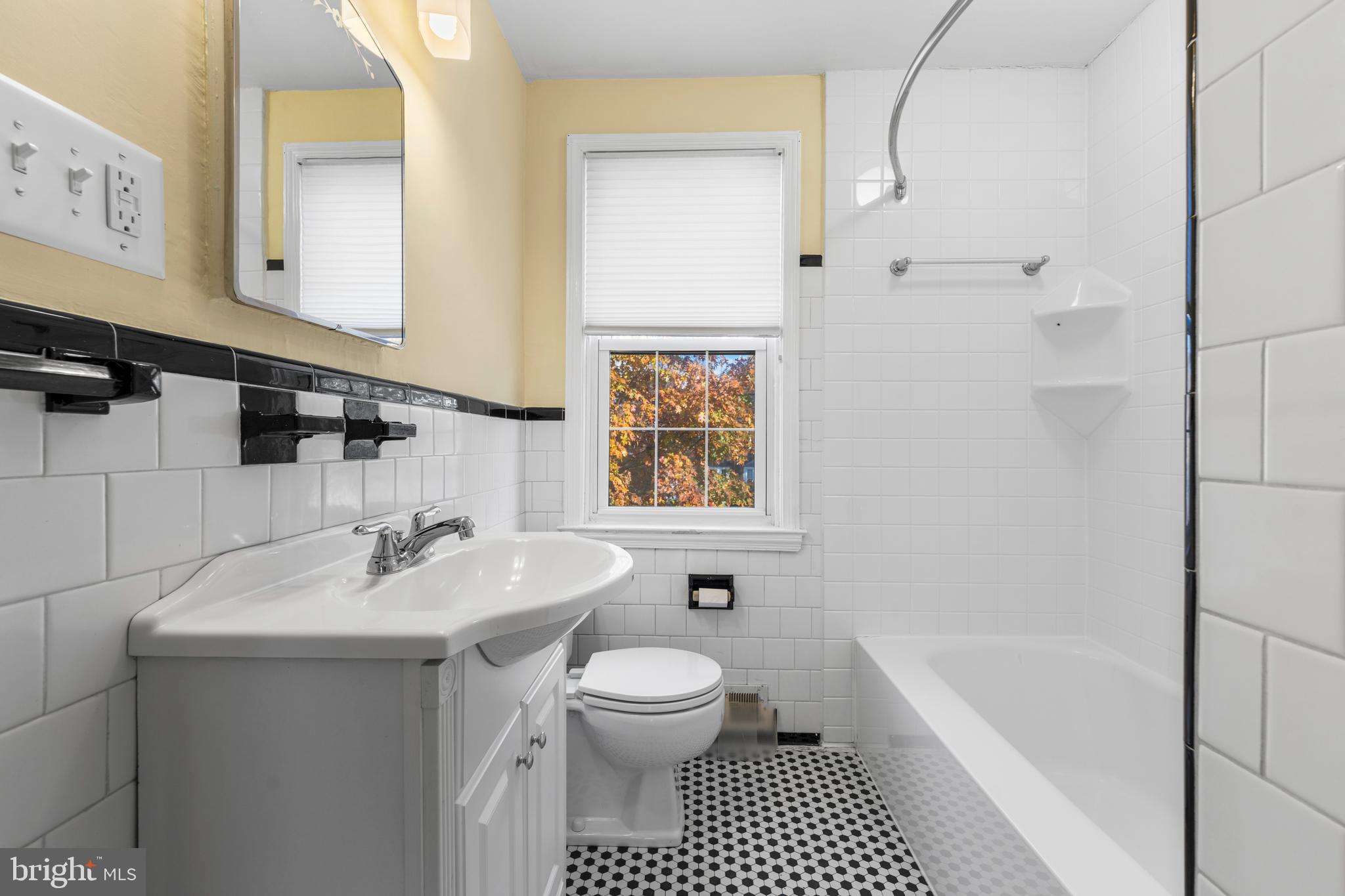 101 Regester Avenue Baltimore, MD 21212 - Photo 13 of 19 a bathroom with a sink a toilet and shower