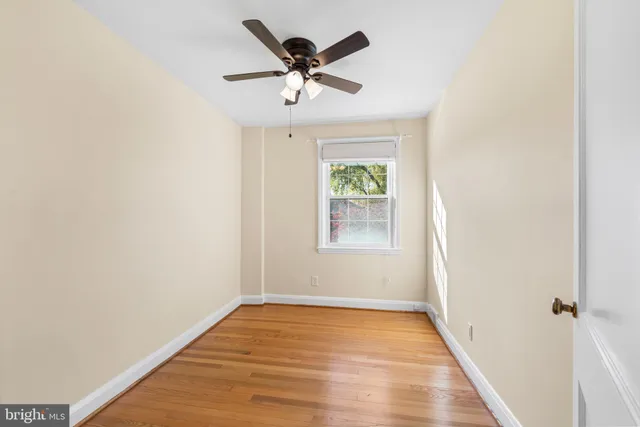 a view of empty room with wooden floor