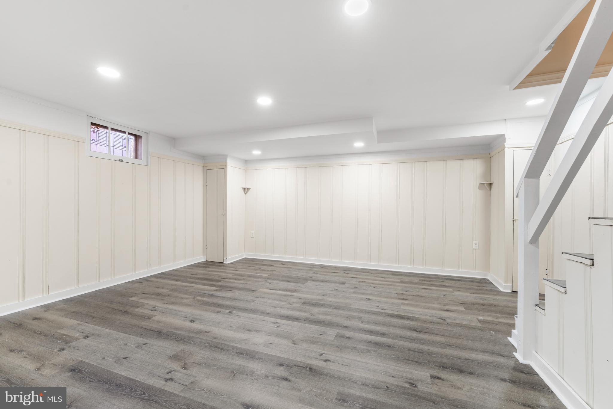 101 Regester Avenue Baltimore, MD 21212 - Photo 17 of 19 a view of an empty room with wooden floor and a window