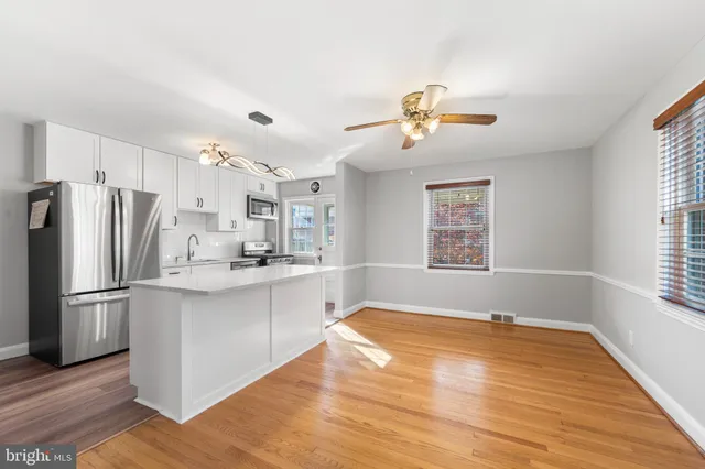a view of a kitchen with a sink dishwasher and a refrigerator