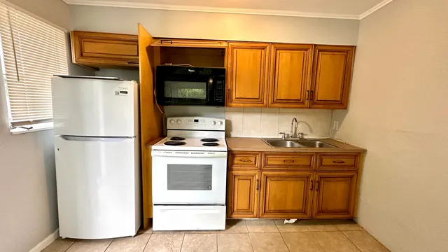 a kitchen with a stove and a refrigerator