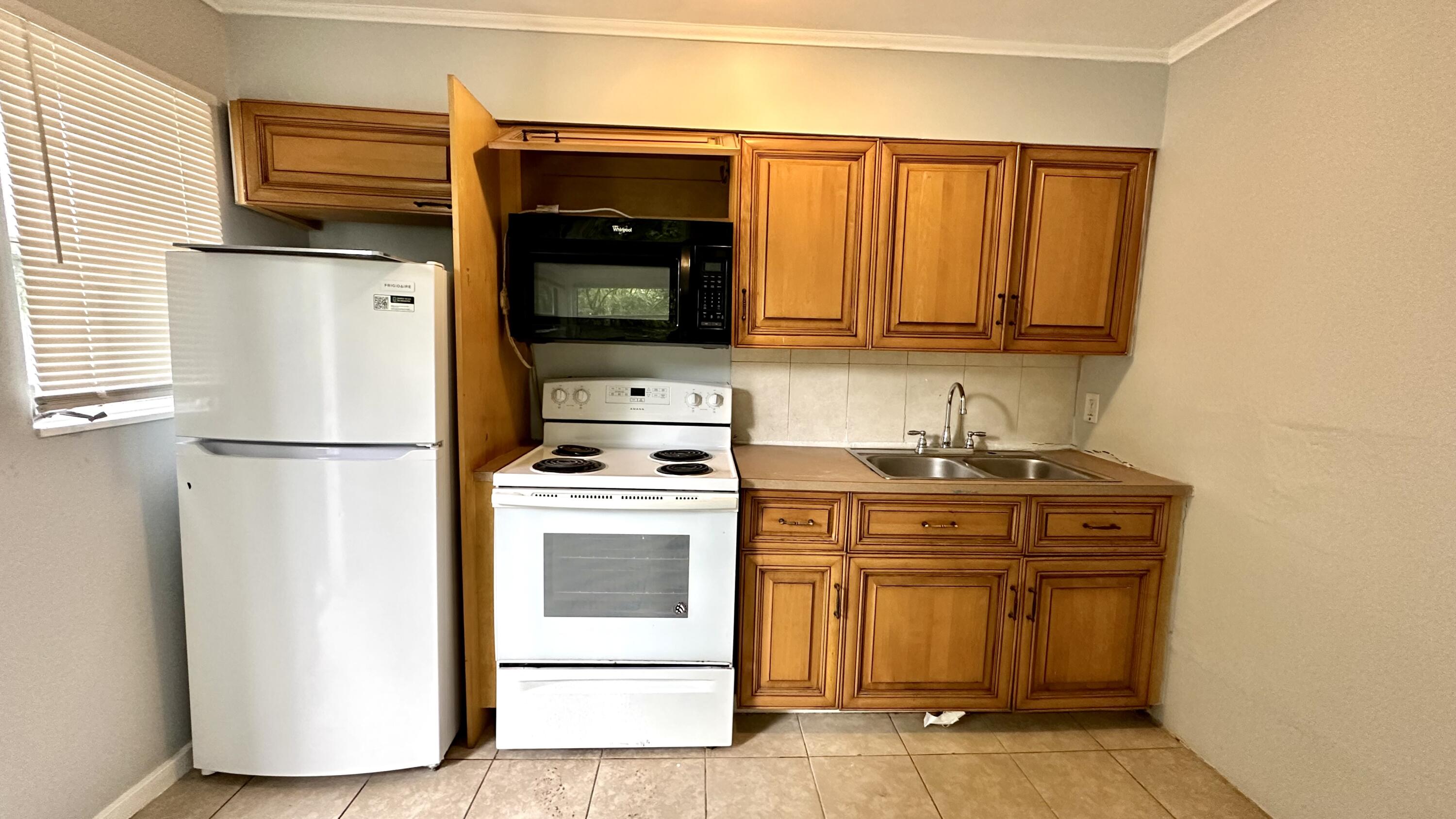 3804 Miller Avenue, Unit C West Palm Beach, FL 33405 - Photo 1 of 10 a kitchen with a stove and a refrigerator