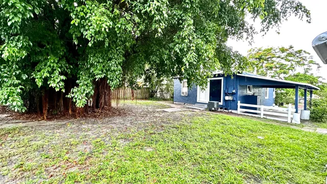 a view of a house with backyard porch and sitting area