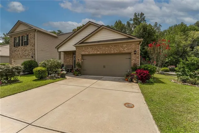 a front view of a house with garden