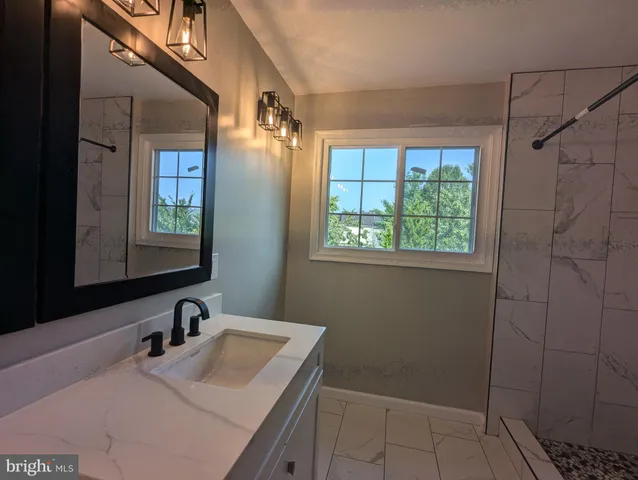 a bathroom with a double vanity sink and a mirror