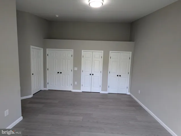 a view of hallway with wooden floor