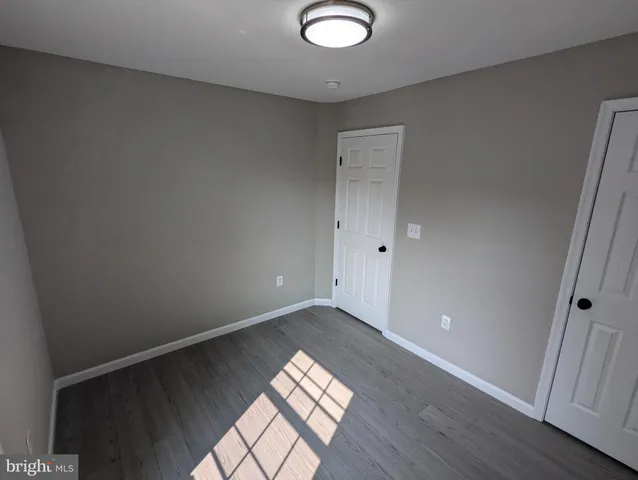 a bathroom with a tub a sink and glass door