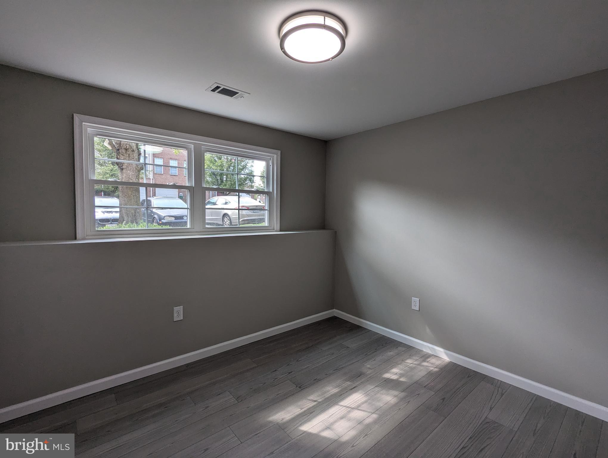 17415 Denali Place Dumfries, VA 22025 - Photo 32 of 55 an empty room with wooden floor and windows