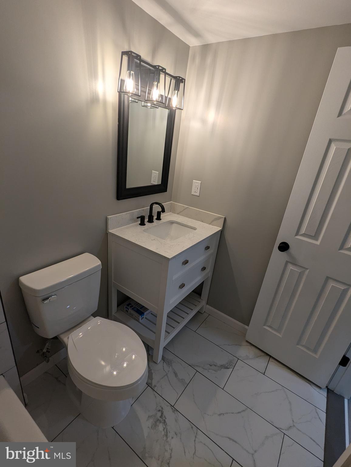 17415 Denali Place Dumfries, VA 22025 - Photo 34 of 55 a bathroom with a toilet sink and mirror