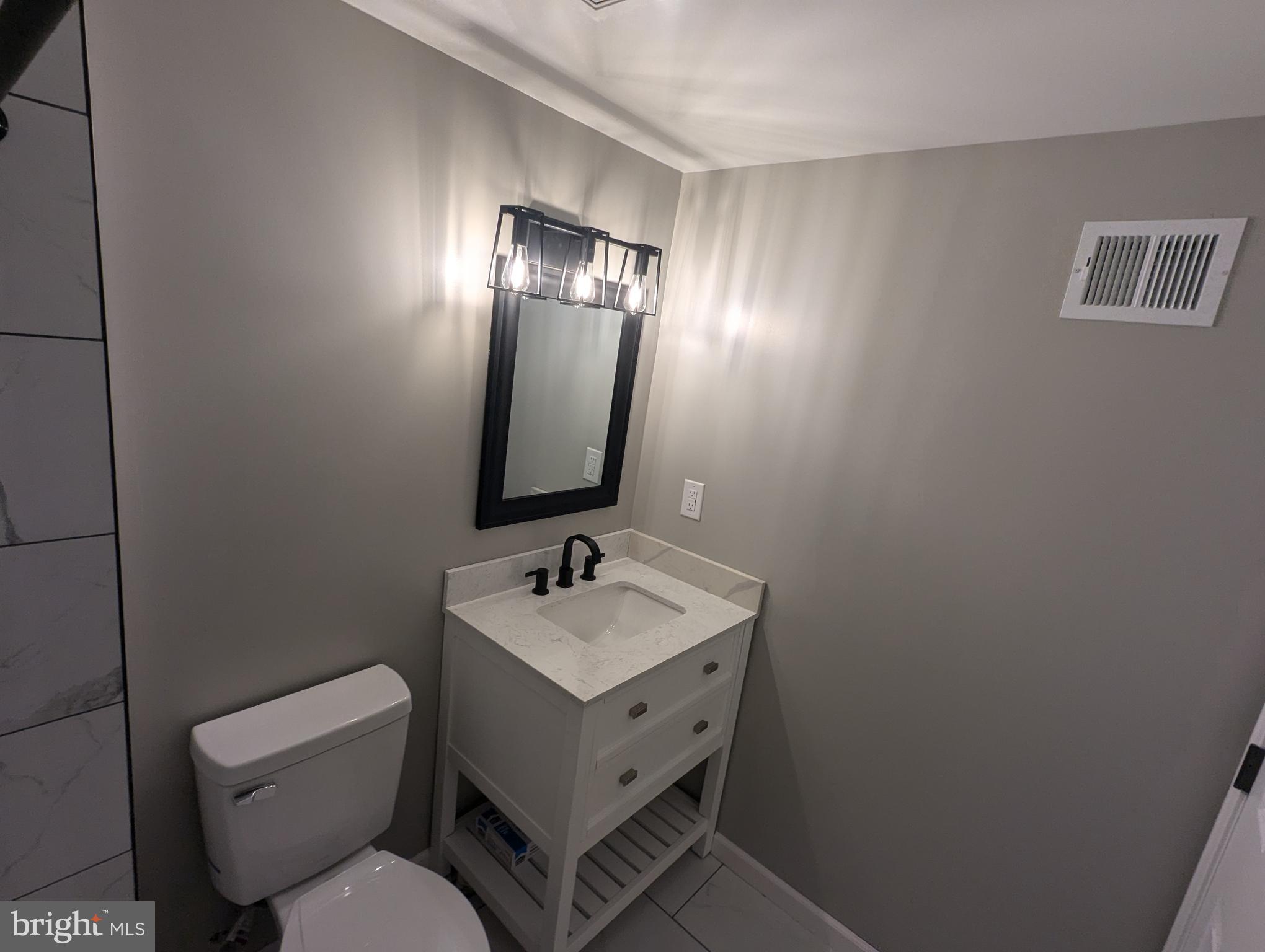 17415 Denali Place Dumfries, VA 22025 - Photo 35 of 55 a bathroom with a toilet sink and mirror