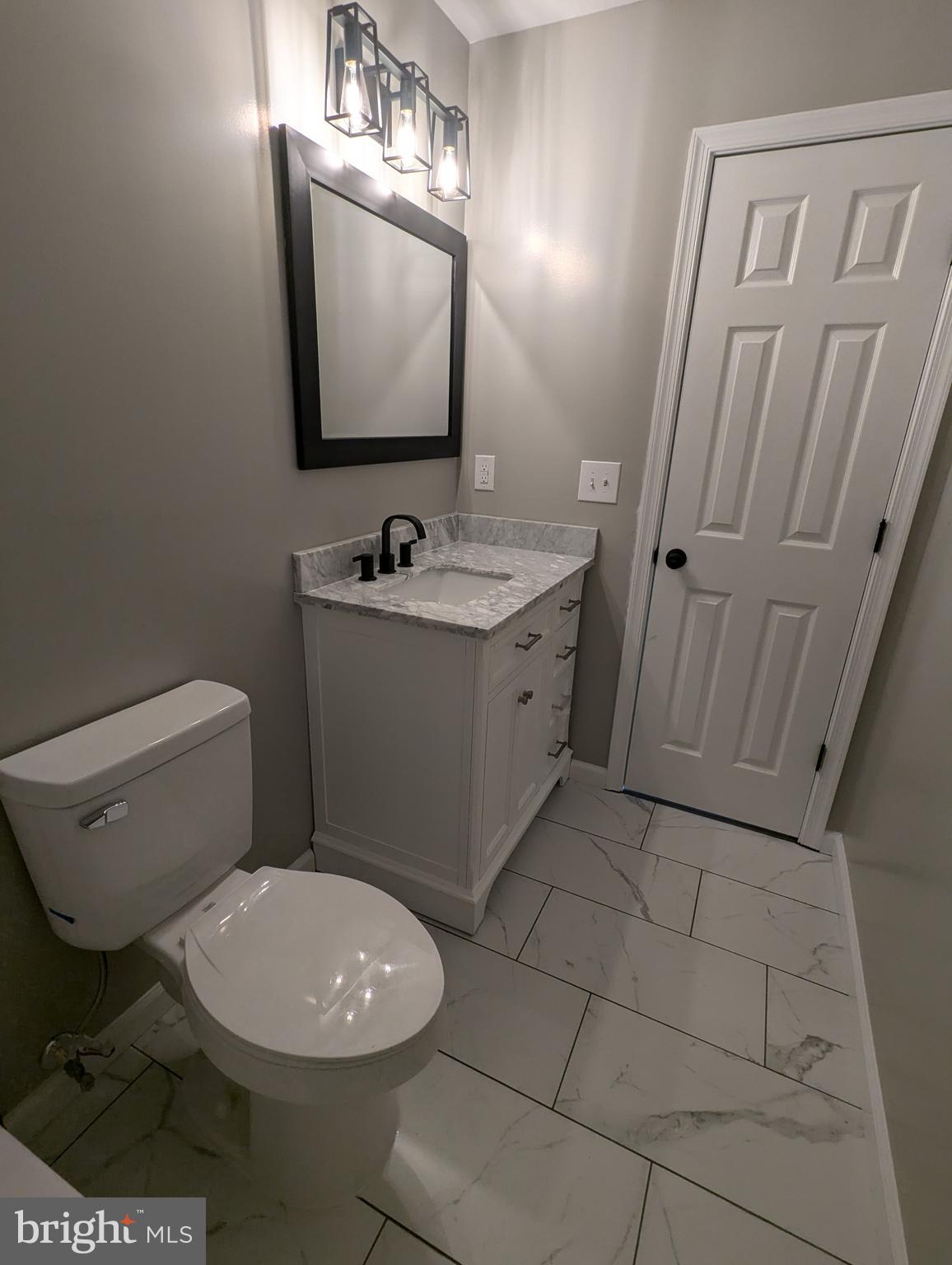 17415 Denali Place Dumfries, VA 22025 - Photo 36 of 55 a bathroom with a toilet a sink a mirror and vanity
