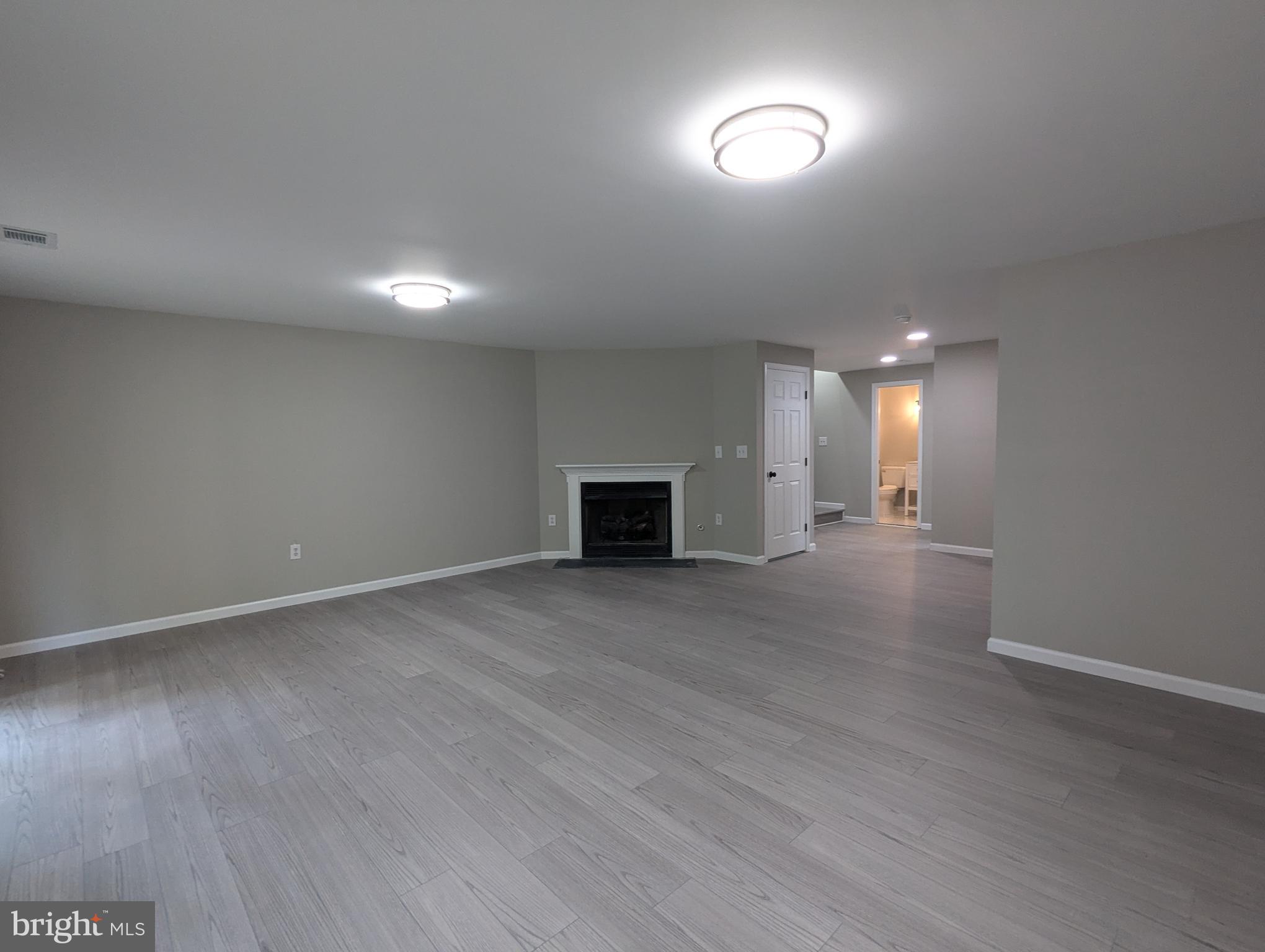 17415 Denali Place Dumfries, VA 22025 - Photo 37 of 55 an empty room with wooden floor and windows