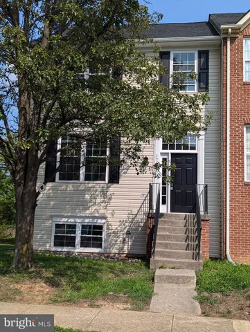 a view of a house with wooden fence