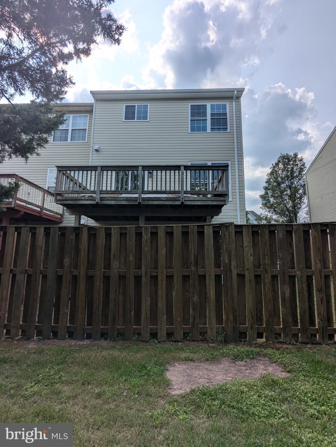 17415 Denali Place Dumfries, VA 22025 - Photo 45 of 55 a view of a house with wooden fence