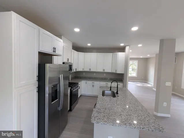 a kitchen with a refrigerator and a sink
