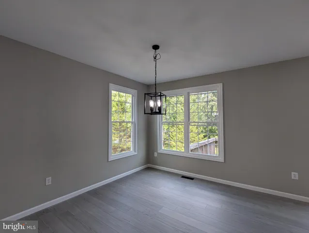 a white toilet sitting next to a white sink