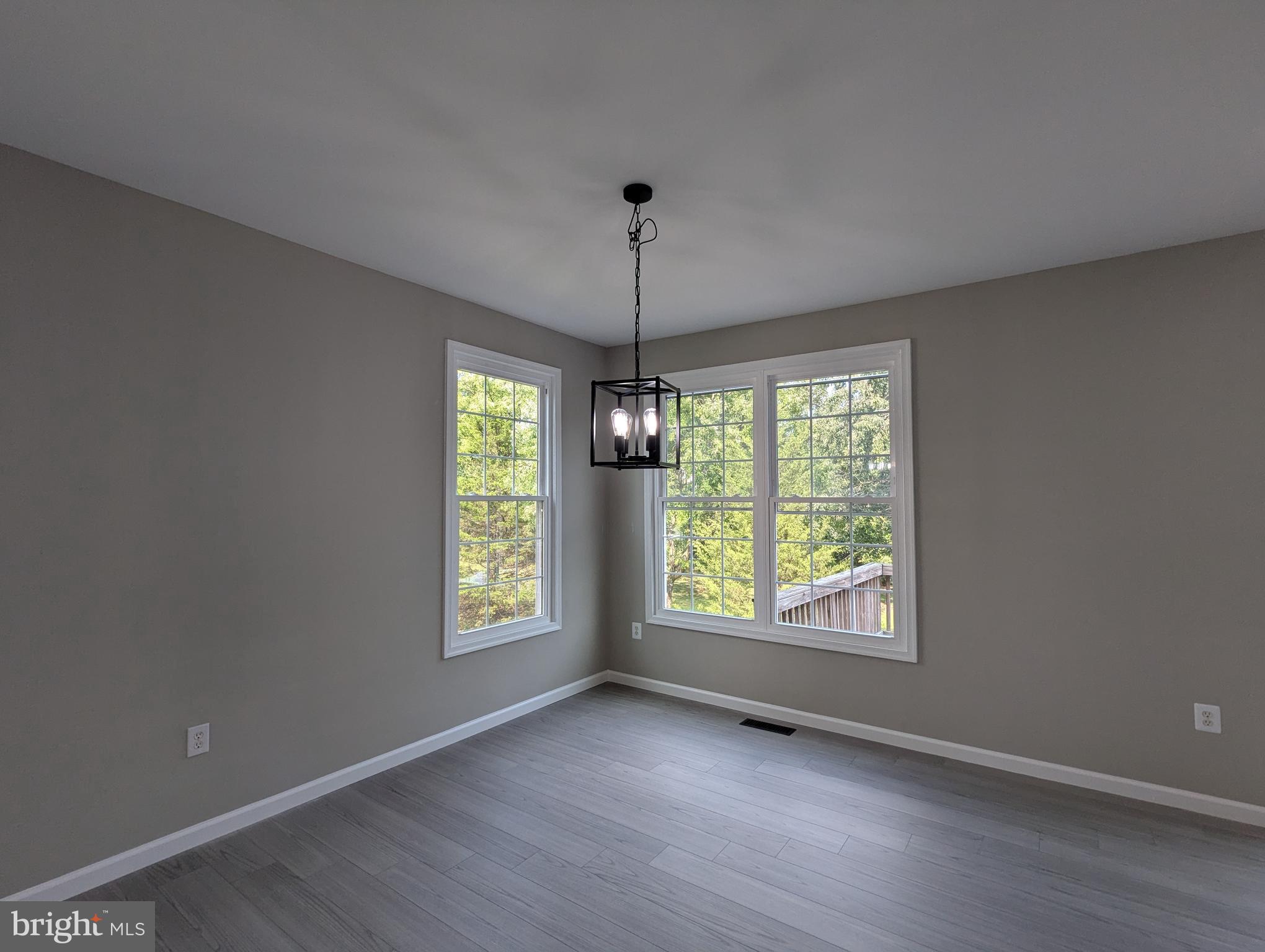 17415 Denali Place Dumfries, VA 22025 - Photo 10 of 55 a view of an empty room with window and wooden floor