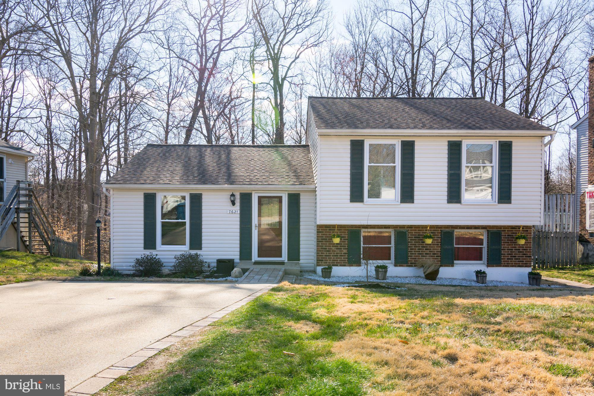 7621 Fallswood Way Lorton, VA 22079 - Photo 2 of 26 a front view of a house with a yard