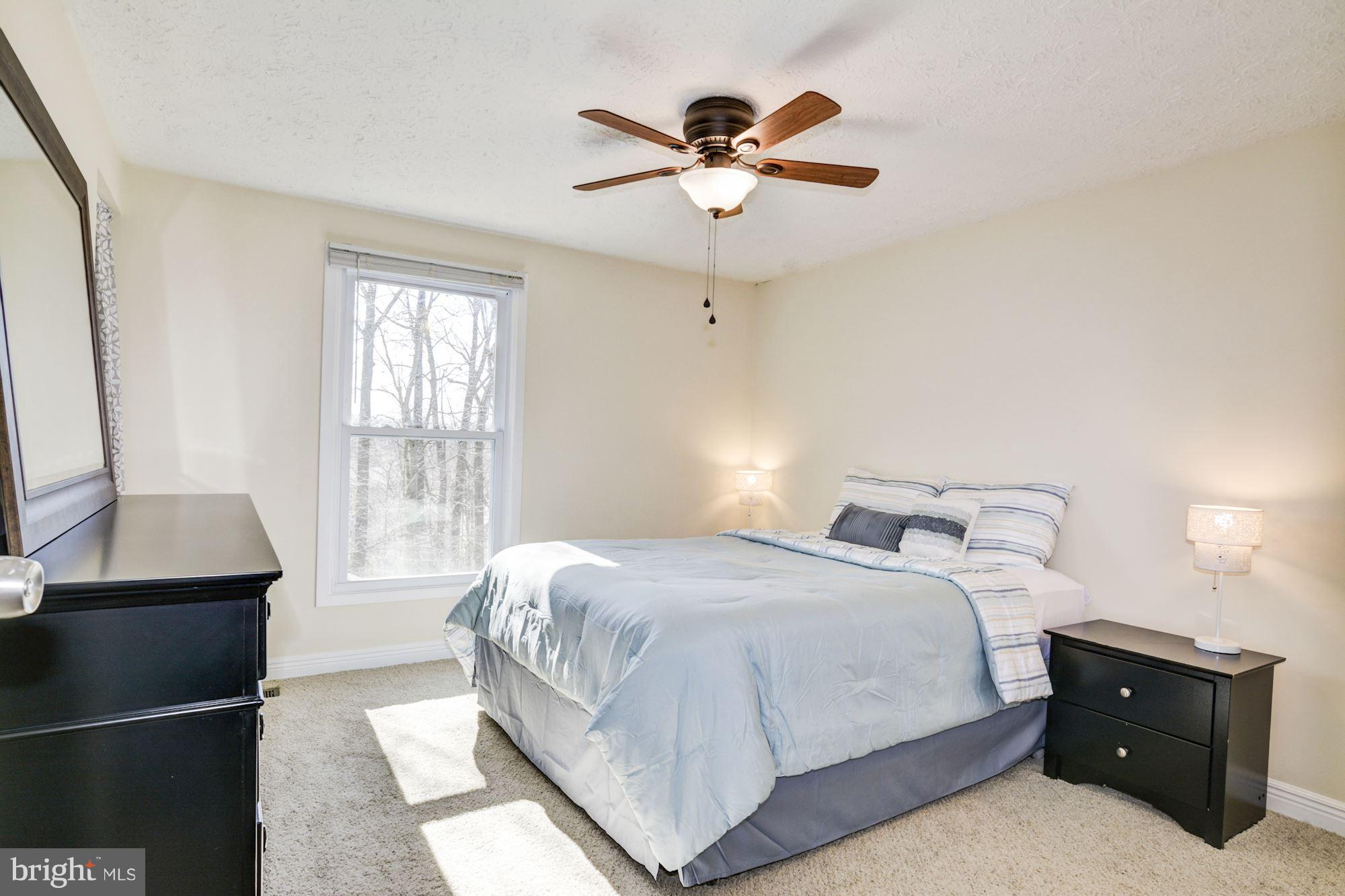 7621 Fallswood Way Lorton, VA 22079 - Photo 13 of 26 a bedroom with a bed and a window