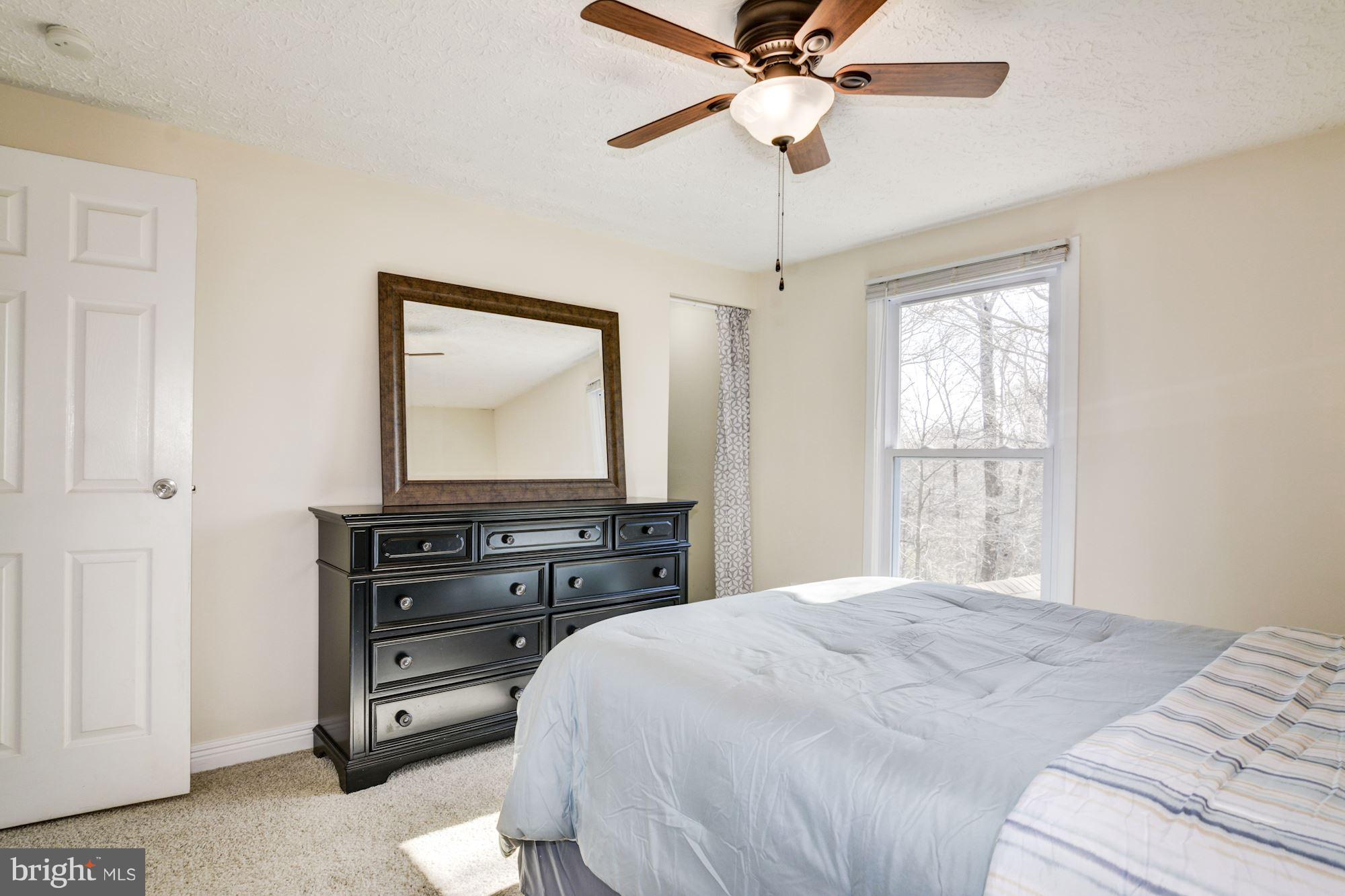 7621 Fallswood Way Lorton, VA 22079 - Photo 14 of 26 a bedroom with a bed and a flat screen tv