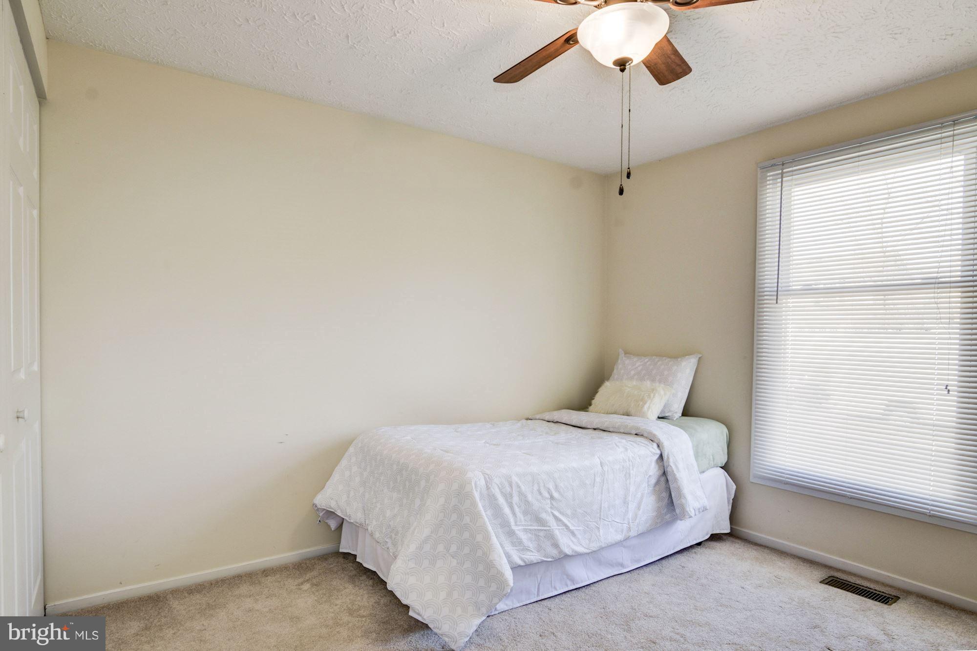7621 Fallswood Way Lorton, VA 22079 - Photo 16 of 26 a bedroom with a bed and a window