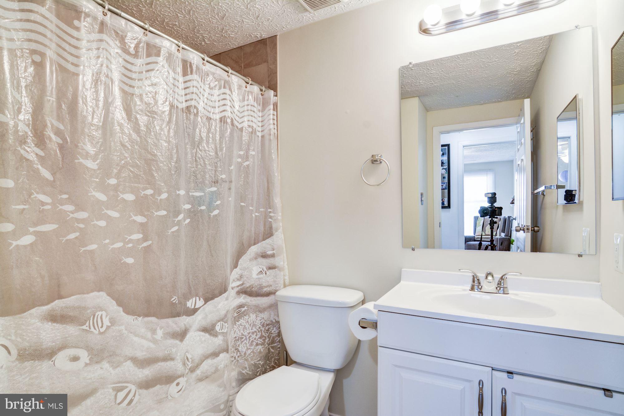 7621 Fallswood Way Lorton, VA 22079 - Photo 19 of 26 a bathroom with a sink toilet and shower