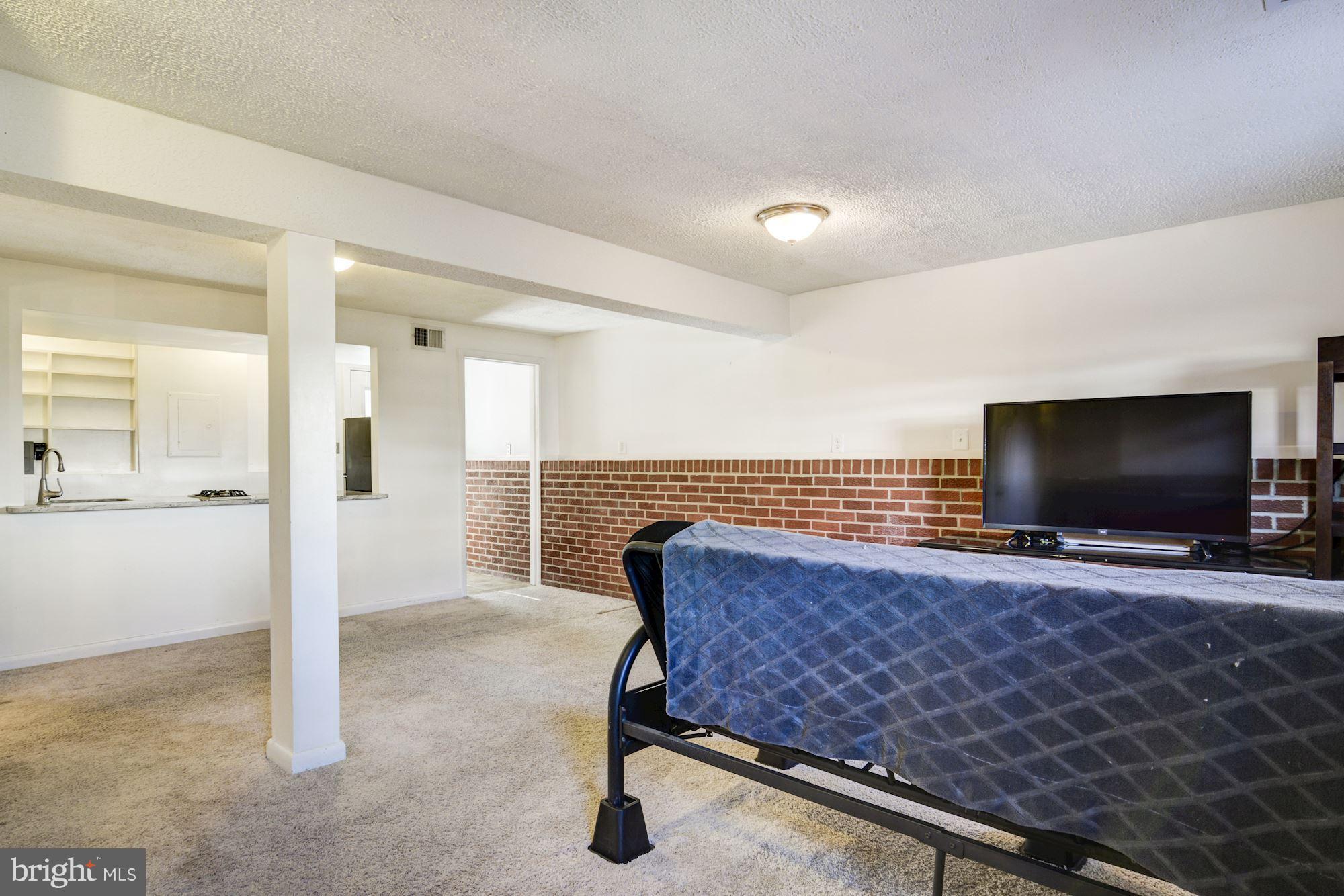 7621 Fallswood Way Lorton, VA 22079 - Photo 20 of 26 a living room with furniture and a flat screen tv
