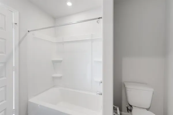 a bathroom with a bathtub and a toilet
