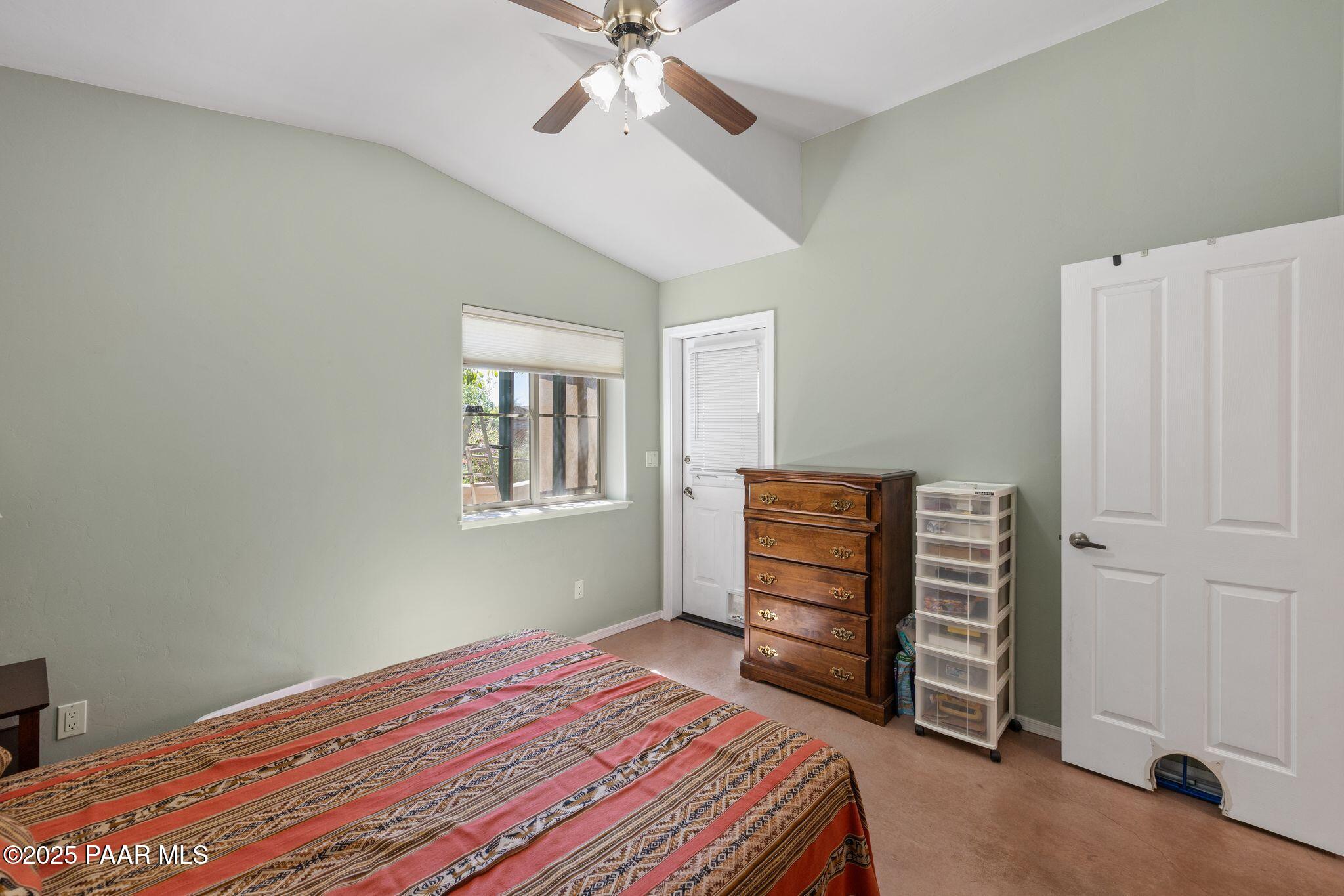 277 Jacob Lane Prescott, AZ 86303 - Photo 17 of 38 a bedroom with a bed and a chandelier