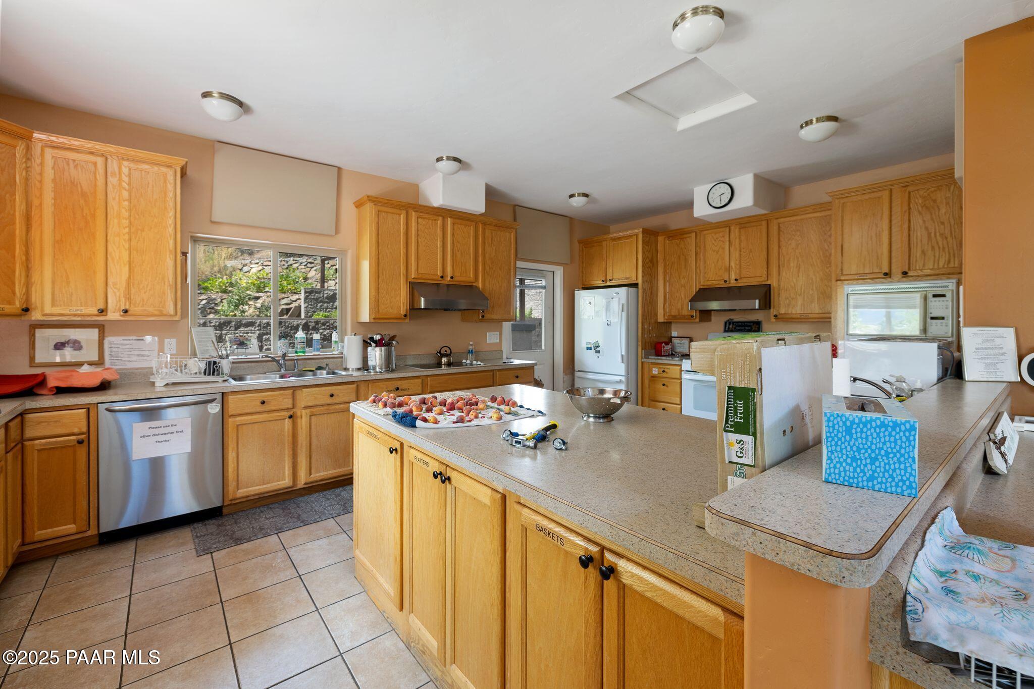 277 Jacob Lane Prescott, AZ 86303 - Photo 31 of 38 a kitchen with stainless steel appliances granite countertop sink stove top oven and cabinets