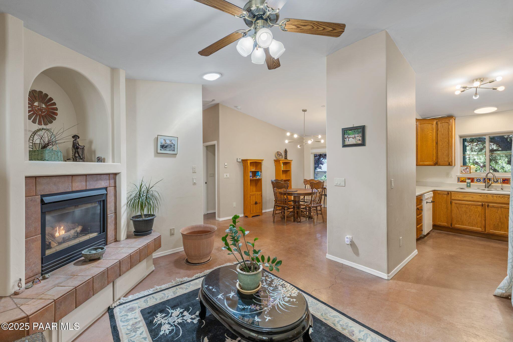 277 Jacob Lane Prescott, AZ 86303 - Photo 7 of 38 a living room with furniture a fireplace and a chandelier