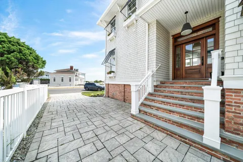 a view of a patio with table and chairs with wooden floor and fence