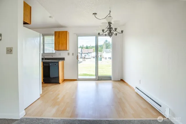 a view of a kitchen with wooden floor and a ceiling fan