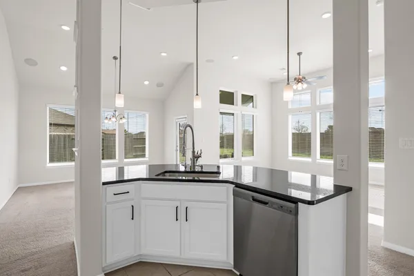 a kitchen with granite countertop a sink and a window