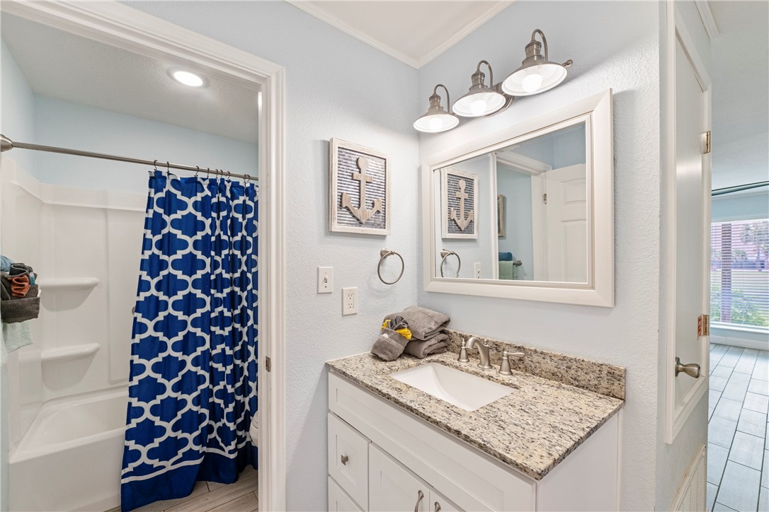 800 Beach Access Road, Unit 111 Port Aransas, TX 78373 - Photo 11 of 30 a bathroom with a sink and a mirror